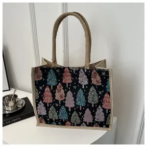 Detail of Christmas tree jacquard weave pattern on a linen tote bag with jute handles