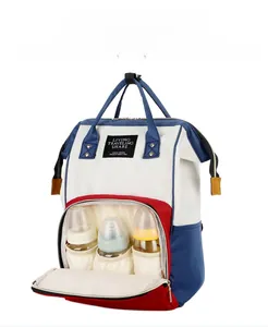 Detail view of large capacity diaper bag with front pockets for three baby bottles