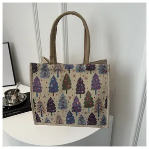 Detailed texture of linen tote bag featuring colorful Christmas tree prints and handles