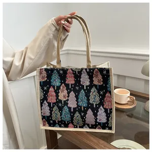 Close-up of jacquard woven Christmas tree patterns on linen tote bag with jute handles