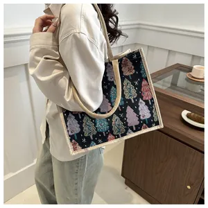Linen tote bag with Christmas tree pattern shown on a shoulder in a cozy home setting