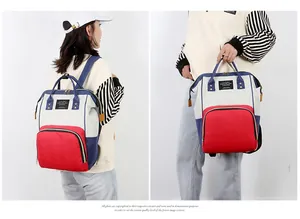 Close-up of tricolor diaper bag featuring durable canvas and reinforced dual handles