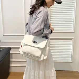 Minimalist ivory canvas messenger bag with stylish letter patch for men and women