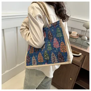 Detail of Christmas tree pattern tote bag with round rope handles on model shoulder