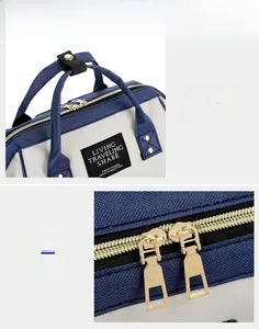 Detail of comfortable carry handle and smooth double metal zippers on the diaper bag