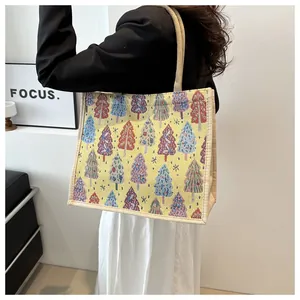 Linen tote bag with woven Christmas tree patterns shown on a model in a modern room