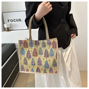 Detail of woven tote bag with colorful pine tree patterns and thick hemp rope handles
