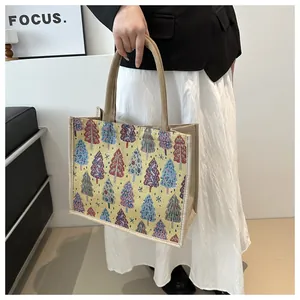 Detail of jute tote bag featuring colorful woven tree patterns and soft padded handles