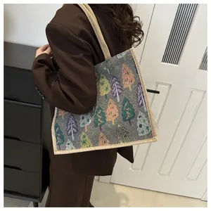 Detailed texture of linen tote bag featuring colorful geometric tree patterns