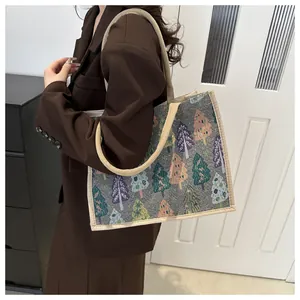 Detailed texture of linen tote bag with colorful tree pattern on brown suit model
