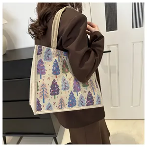 Close-up of stylish linen tote bag with colorful Christmas tree woven patterns