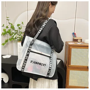 Macro detail of transparent PVC tote bag with FASHION lettering and trendy wide strap