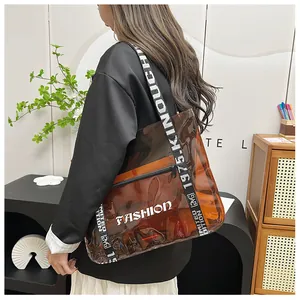 Detail of transparent brown tote bag with fashion print and adjustable woven strap
