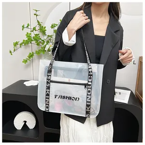 Detailed view of transparent tote bag with FASHION print and lettered black strap