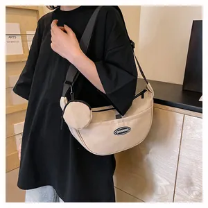 Detail of beige nylon half-moon crossbody bag with detachable round coin purse