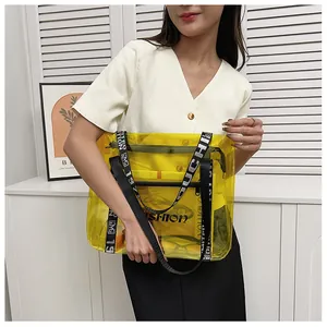 Detail of yellow transparent PVC tote bag with letter print straps and internal pouch