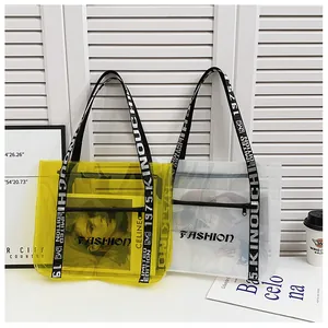 Detail of transparent PVC tote bags in yellow and clear with letter print woven straps