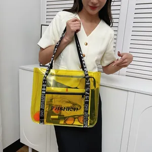 Yellow transparent PVC tote bag with stylish lettered handles for beach and travel