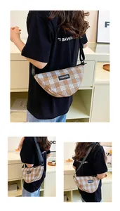 Detail of checkered crescent bag with adjustable black strap and fashion label on canvas