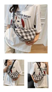 Detail of checkered dumpling bag with FASHION patch and adjustable canvas strap