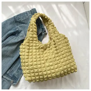 Close-up of vibrant yellow popcorn bubble texture fabric on a stylish tote bag