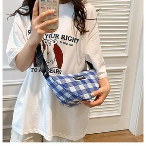 Close-up of blue and white checkered canvas fanny pack with black FASHION label