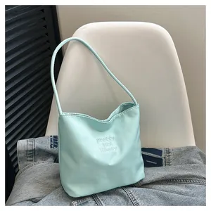 Detailed embroidery of Pretty and Libety on mint green nylon shoulder tote bag