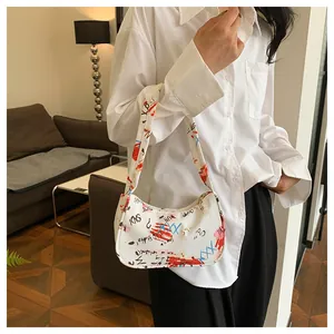 Detailed view of fashionable white underarm bag with colorful artistic graffiti prints