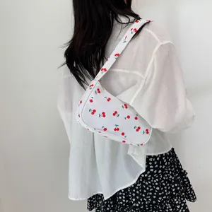 Chic white underarm bag featuring red cherry prints for a minimalist casual style