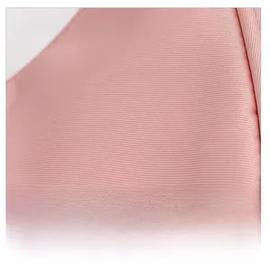 Close-up of soft pink mesh fabric texture on the minimalist crescent shoulder bag