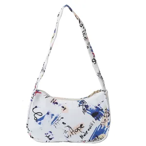 Minimalist white hobo bag with artistic graffiti print and wide shoulder strap