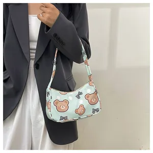 Borsa a spalla verde pastello con orsetti e pois indossata da una modella