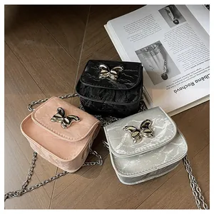 Chic mini bow bags in silver, pink, and black colors with metallic chain straps