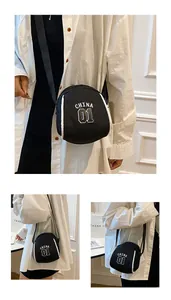 Detail of black nylon shell bag with white contrast piping and China 01 athletic print