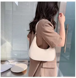 Minimalist beige hobo bag for women shown in a stylish urban fashion street setting