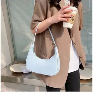Minimalist light blue crescent shoulder bag for women with matte faux leather texture