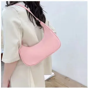 Chic pink crescent hobo bag for women with streamlined nylon finish and matching shoulder strap