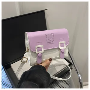 Close-up of cute cartoon cat embossed detail on purple and white PU leather crossbody bag