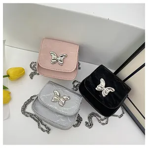 Detailed view of silver, pink, and black mini bow bags with metallic butterfly accents