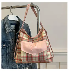 Detailed pink plaid tote bag featuring a leather flap pocket with a bow embroidery