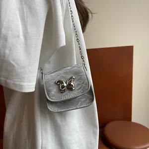 Silver metallic bow mini crossbody bag with wrinkled texture and delicate chain strap
