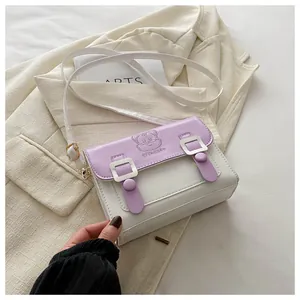 Detail of cute cat embossing on white and purple Cambridge crossbody bag with buckles
