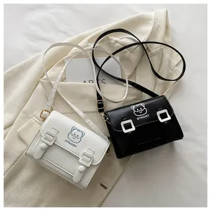Close-up of cat embroidery and buckle straps on mini PU crossbody satchel bags
