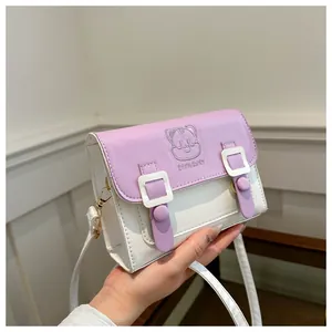 Detail of a mini lilac and cream crossbody bag featuring a 3D cartoon cat and gold metal hardware