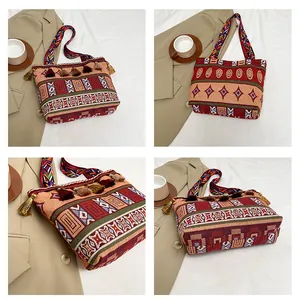 Detailed macro view of bohemian woven tote bag with fringe accents and geometric patterns