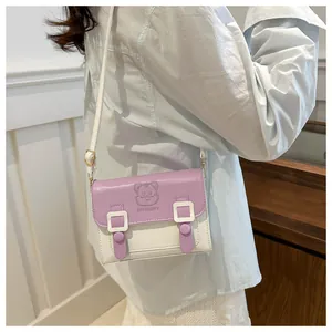 Detail of lavender and cream PU leather crossbody bag featuring embossed cartoon character