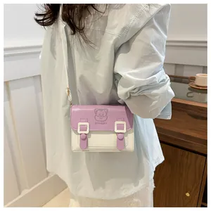 Detail of a mini two-tone crossbody bag with cat embossment and purple flap
