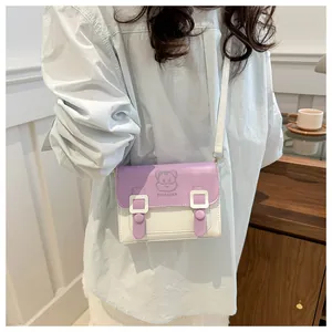Detailed view of the purple and white cartoon crossbody bag worn by a model