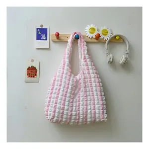Detail of pink and white striped tote bag with bubble waffle texture fabric
