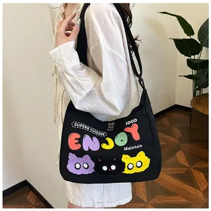 Dettaglio della borsa hobo in tela nera con stampa di gatti colorati e doppia zip